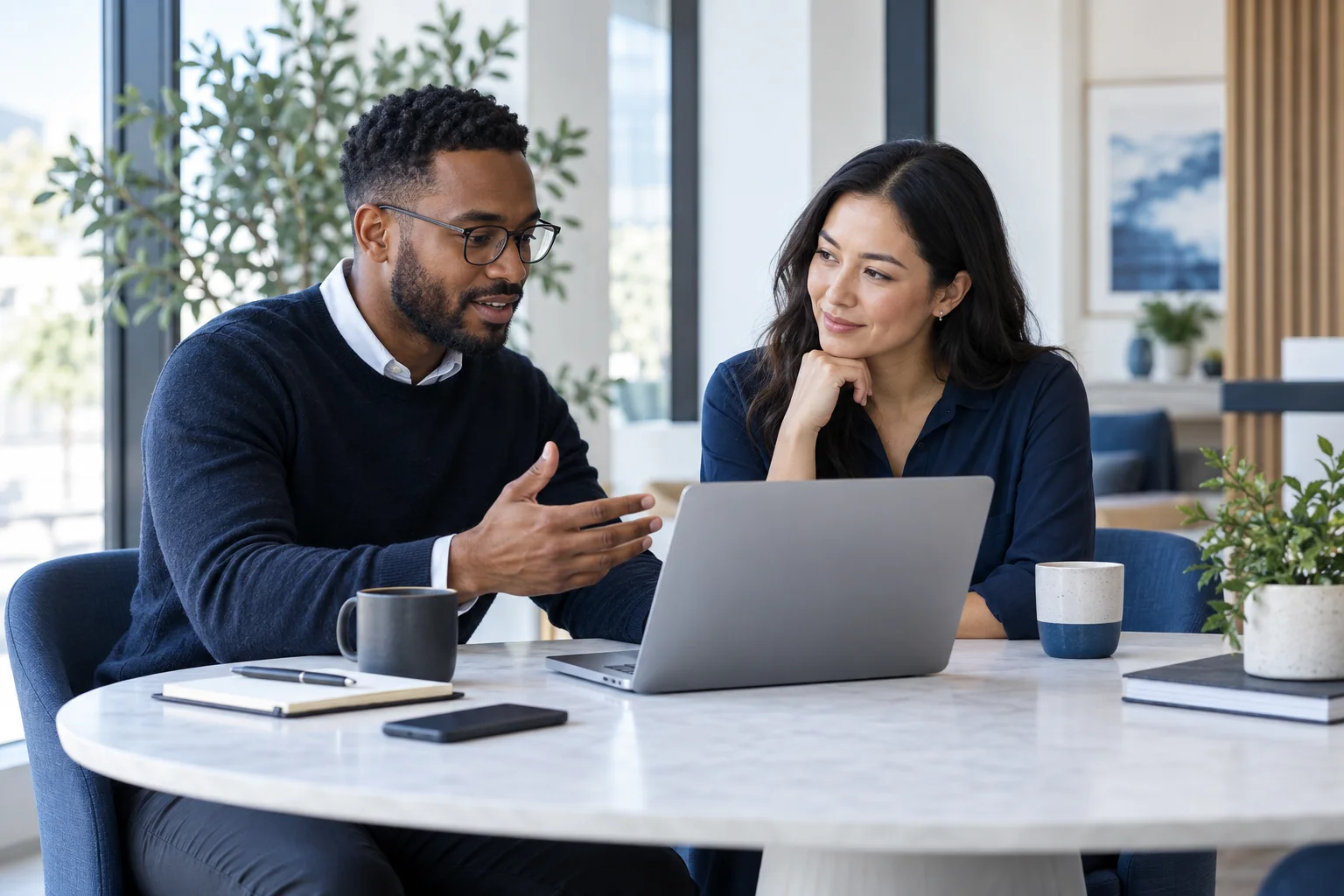 Illustration of two people collaborating around a laptop